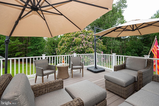 deck featuring an outdoor living space and ceiling fan