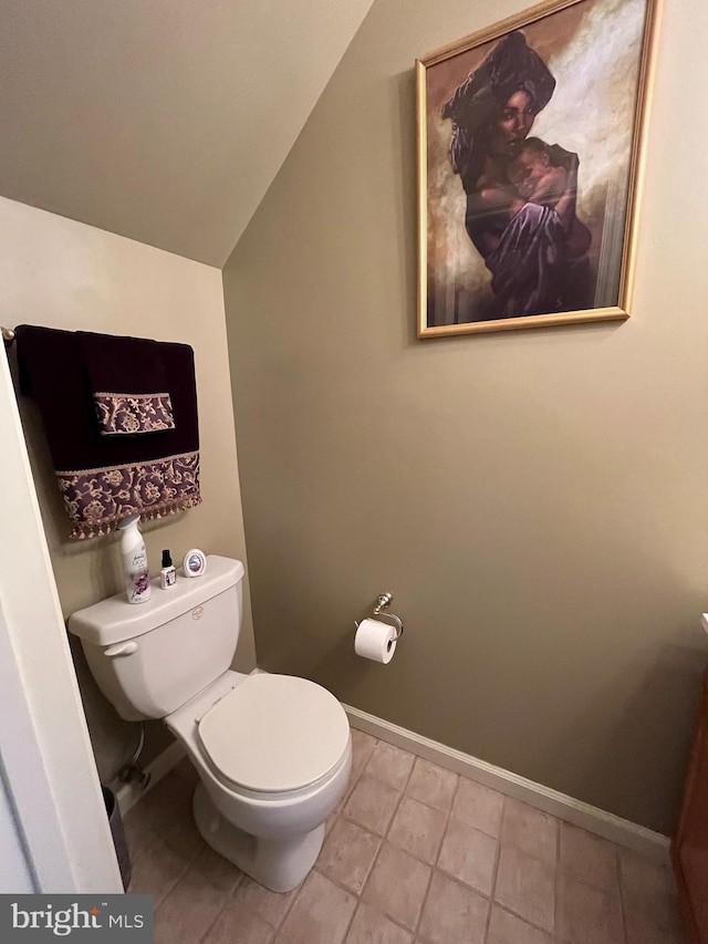 bathroom featuring toilet and vaulted ceiling