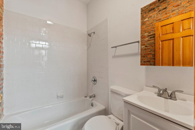 full bathroom featuring vanity, toilet, and tiled shower / bath combo