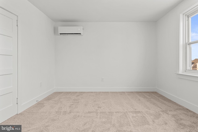 carpeted spare room with a wall unit AC