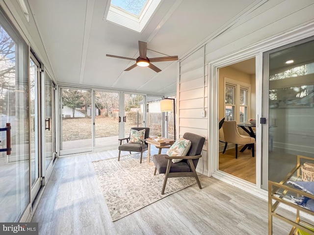 sunroom / solarium with ceiling fan and lofted ceiling with skylight