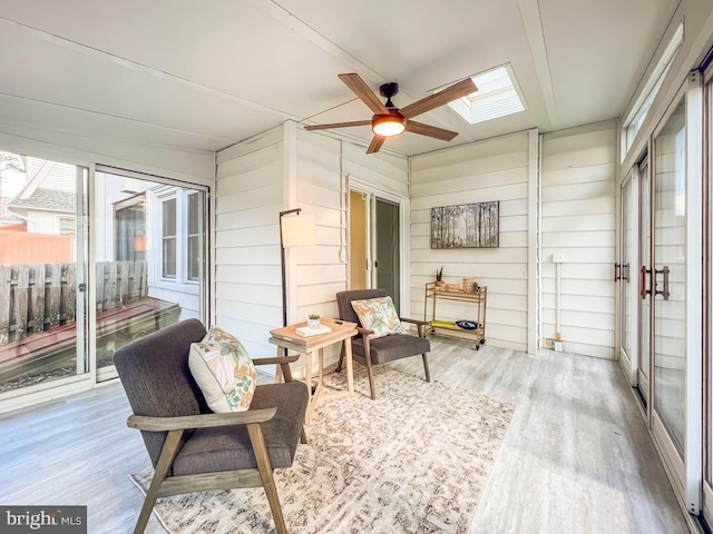 sunroom with ceiling fan and a skylight