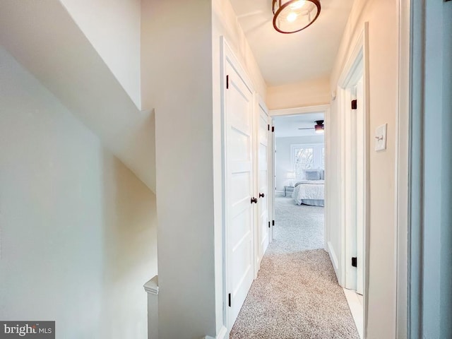 hallway featuring light carpet