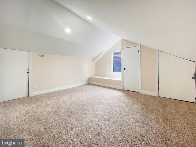 bonus room featuring lofted ceiling and carpet floors