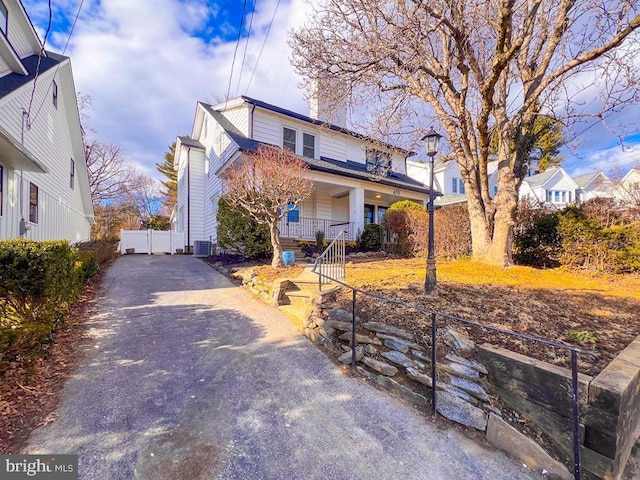 view of front of home featuring cooling unit and covered porch