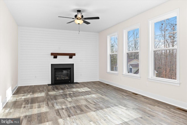 unfurnished living room with hardwood / wood-style floors and ceiling fan