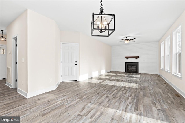 unfurnished living room with hardwood / wood-style floors and ceiling fan