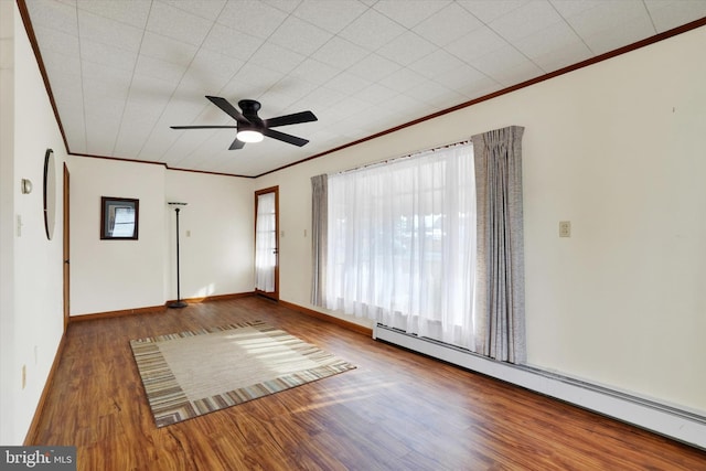 unfurnished room featuring baseboards, ceiling fan, dark wood-style flooring, baseboard heating, and crown molding