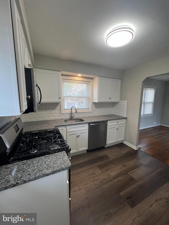 kitchen featuring sink, stainless steel appliances, white cabinets, and light stone countertops