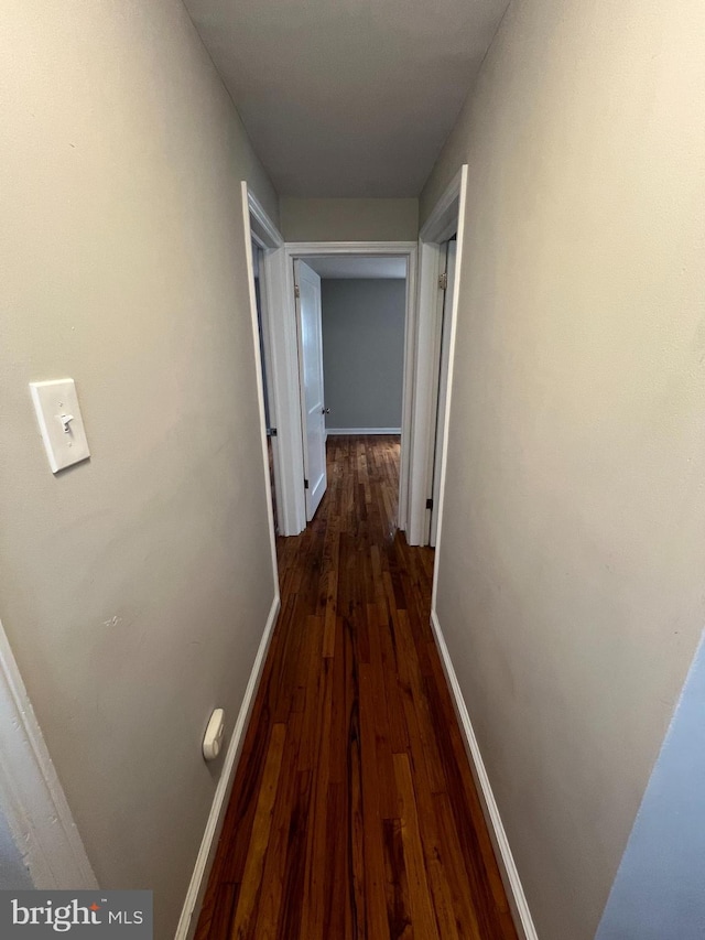 hall with dark wood-type flooring