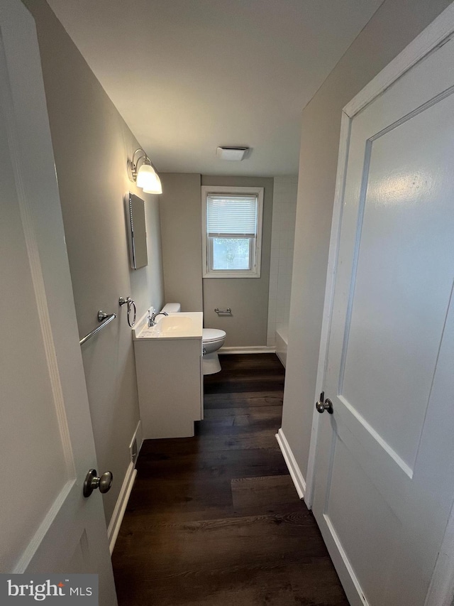 bathroom with vanity, toilet, and wood-type flooring