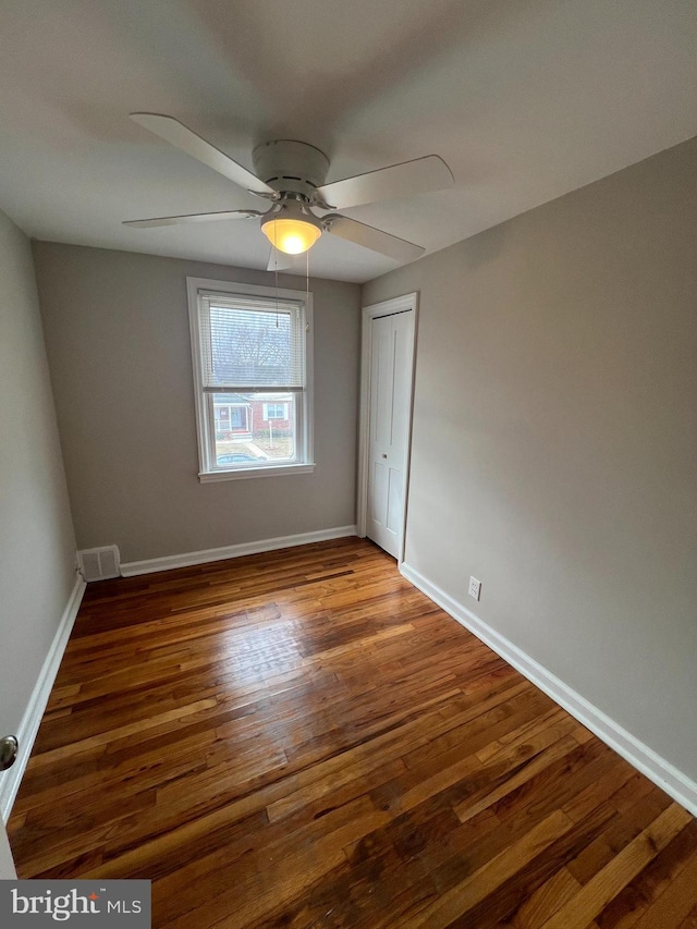 spare room with hardwood / wood-style flooring and ceiling fan