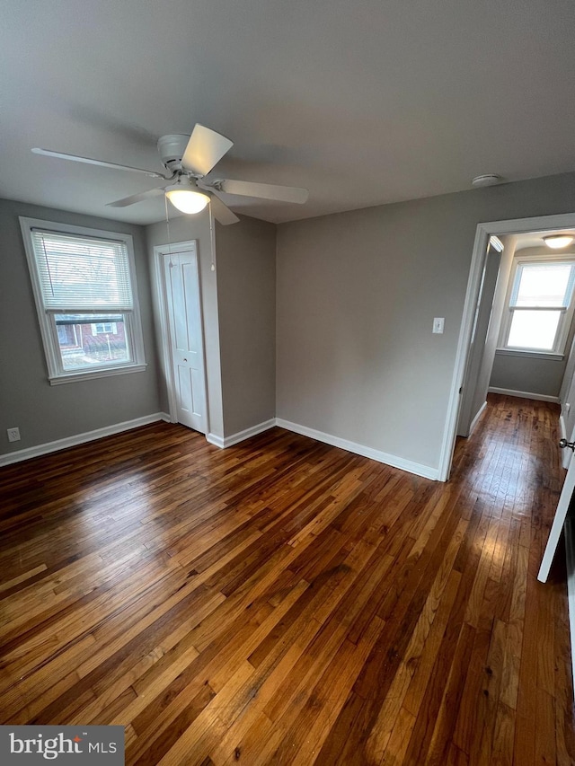 spare room featuring dark wood-type flooring and ceiling fan