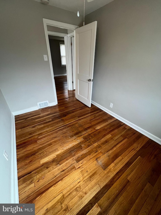 unfurnished room with hardwood / wood-style flooring