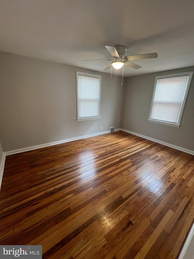 unfurnished room featuring dark hardwood / wood-style flooring and ceiling fan