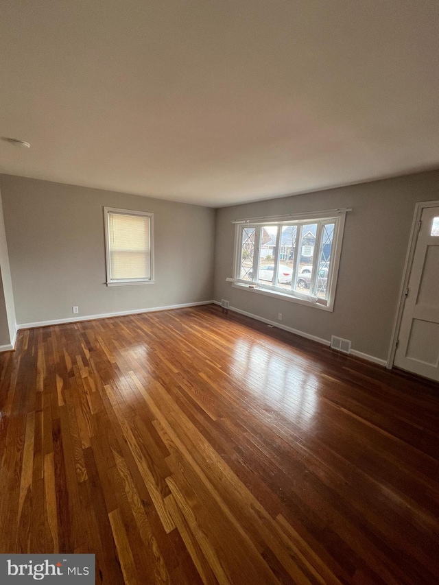 spare room featuring dark wood-type flooring