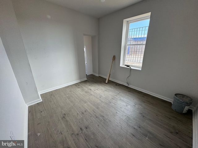 unfurnished room with hardwood / wood-style flooring