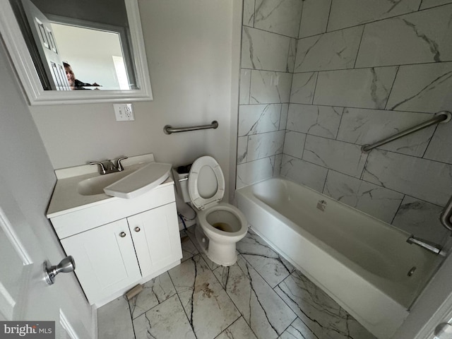 full bathroom featuring tiled shower / bath, vanity, and toilet