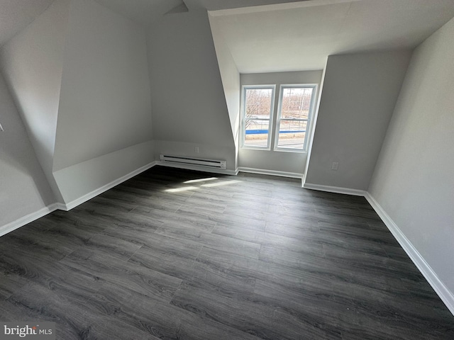 bonus room with a baseboard radiator and dark hardwood / wood-style flooring