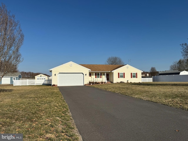 single story home featuring a front lawn and a garage