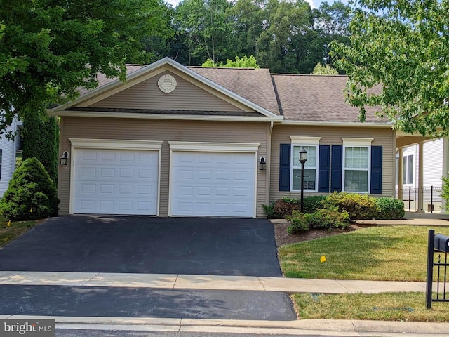 ranch-style home with a garage and a front lawn