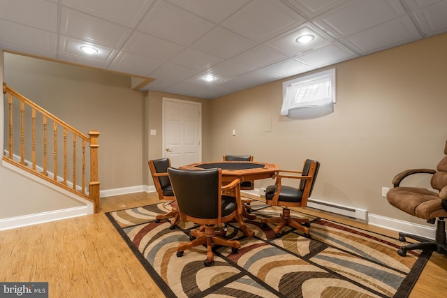 dining space with light hardwood / wood-style floors and a baseboard heating unit