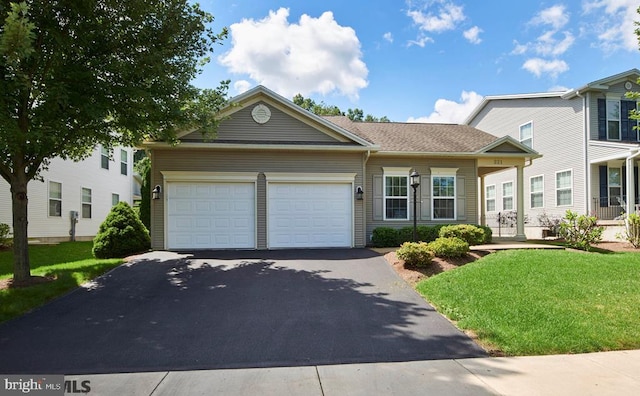 view of front of property featuring a garage and a front yard