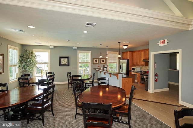 tiled dining room with plenty of natural light