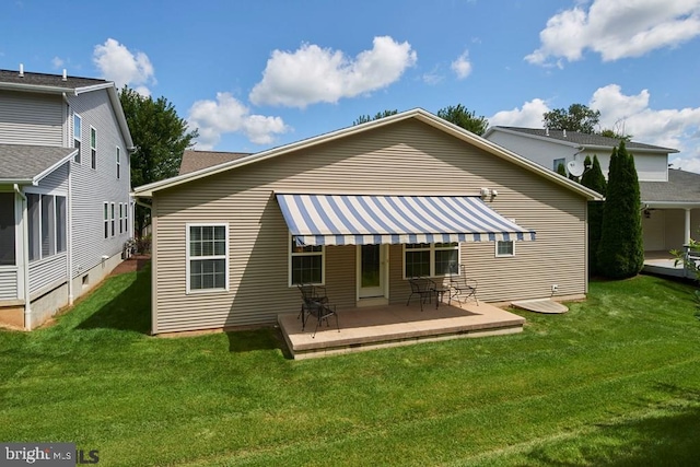 back of house with a patio area and a lawn