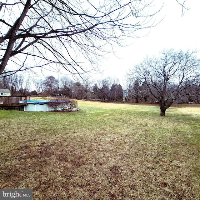 view of yard with a covered pool