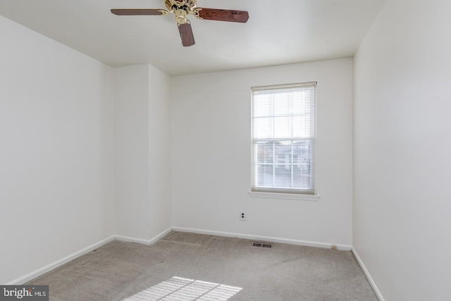 unfurnished room featuring ceiling fan and light carpet