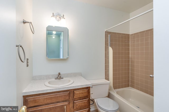 full bathroom with tiled shower / bath, vanity, and toilet