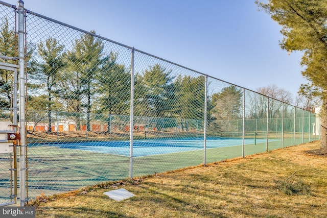 view of sport court featuring a yard