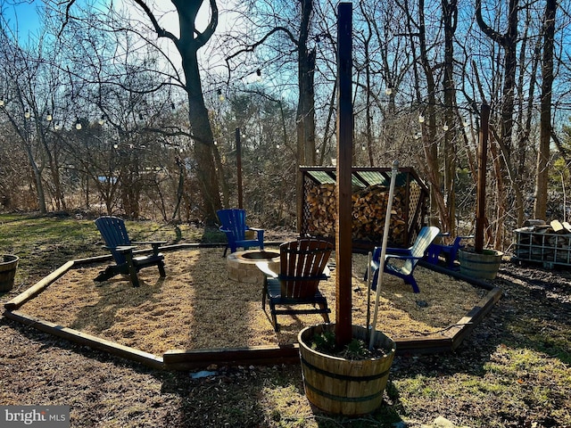 view of playground featuring an outdoor fire pit