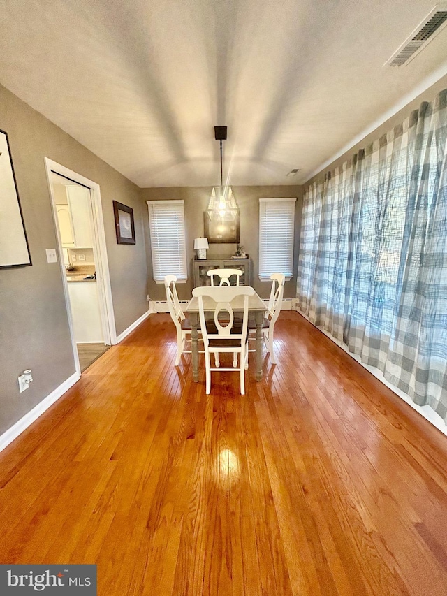 dining room with wood-type flooring