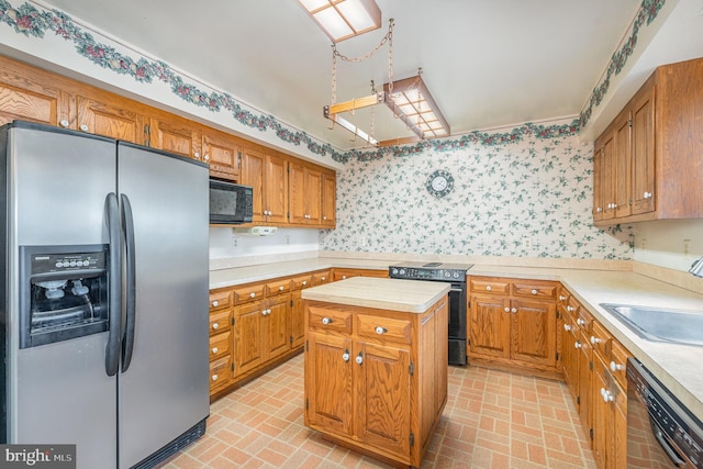 kitchen featuring sink, a kitchen island, and black appliances