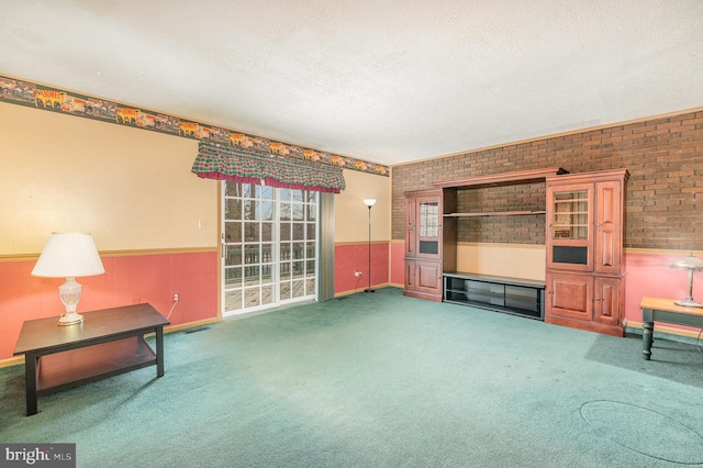 unfurnished living room featuring brick wall, a textured ceiling, and carpet flooring