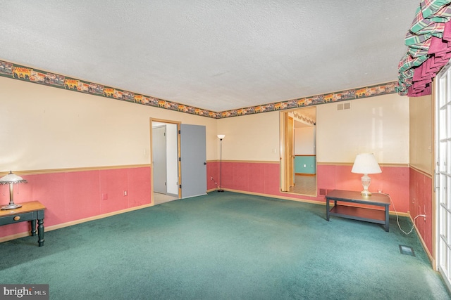 interior space with a textured ceiling and carpet