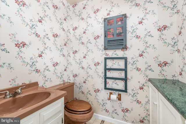 bathroom featuring tile patterned flooring, vanity, and toilet