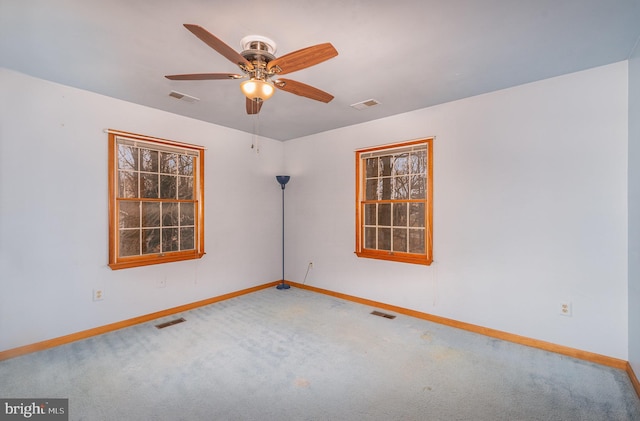 spare room with carpet and ceiling fan