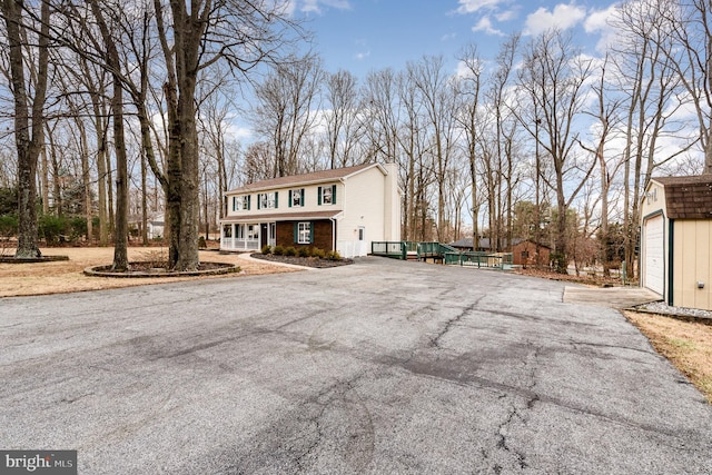 view of front of property with a garage and an outdoor structure