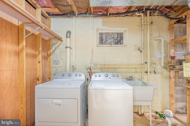 clothes washing area featuring sink and washing machine and clothes dryer