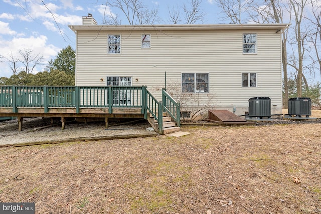 rear view of house with central air condition unit and a deck