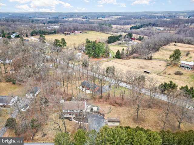 birds eye view of property with a rural view