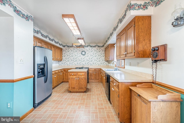 kitchen with stainless steel refrigerator with ice dispenser, dishwasher, sink, and a kitchen island