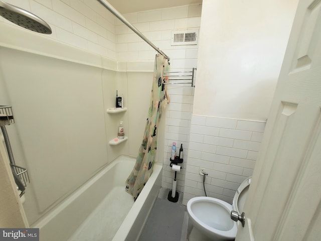 bathroom featuring tile walls, shower / tub combo with curtain, and toilet