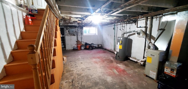 basement with electric panel and water heater