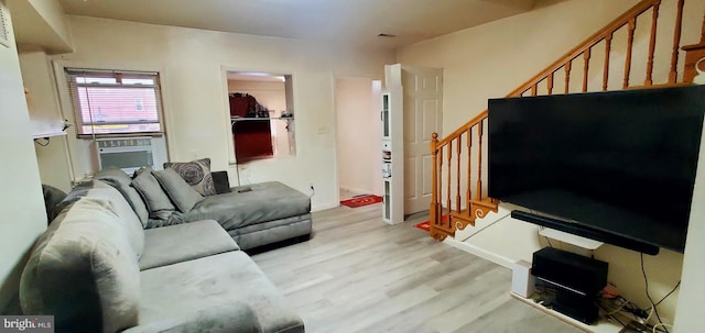 living room with cooling unit and light hardwood / wood-style floors