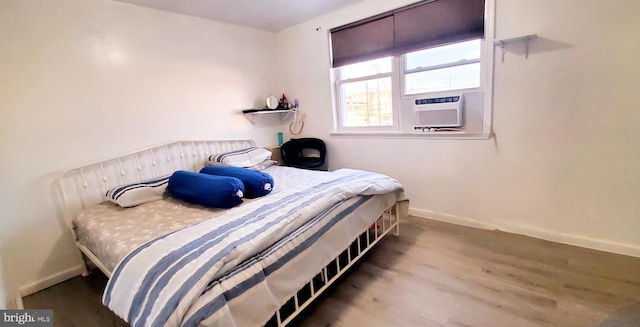 bedroom with hardwood / wood-style flooring