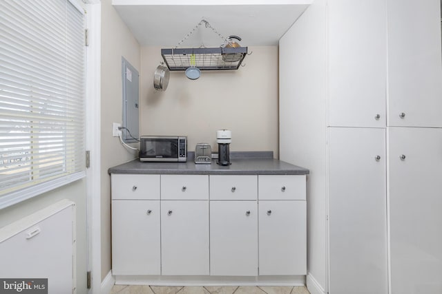 bar featuring white cabinetry